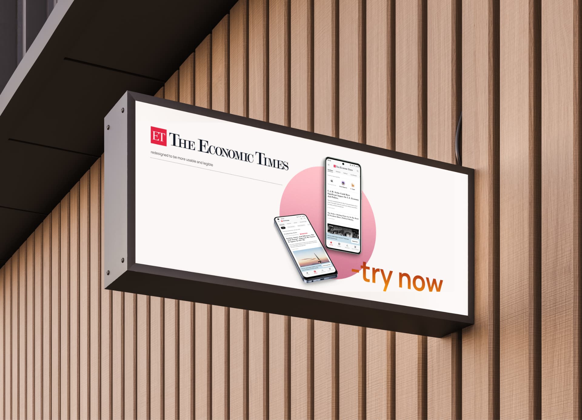 The Economic Times app redesign mockup on a lightbox sign